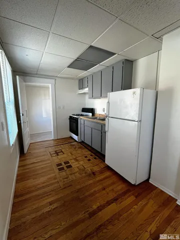 a kitchen with a refrigerator and a stove top oven
