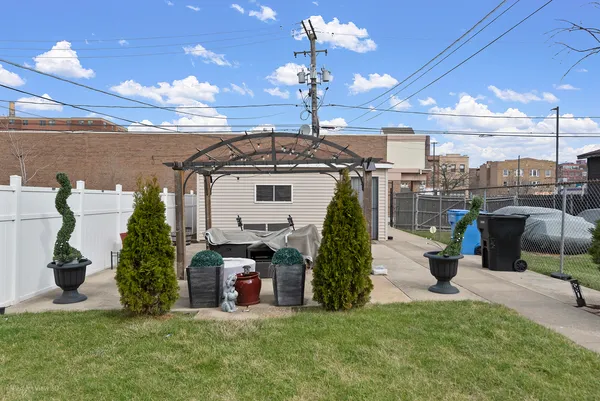 a view of a house with a swimming pool and sitting area