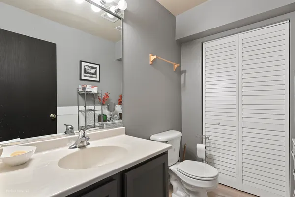 a bathroom with a sink a toilet and mirror