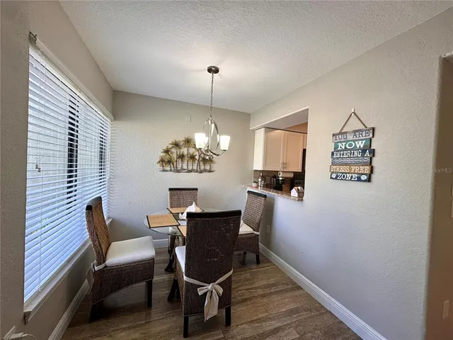 a dining room with furniture and chandelier kitchen view