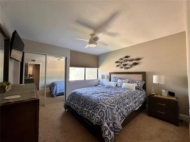 a bedroom with a large bed and a chandelier