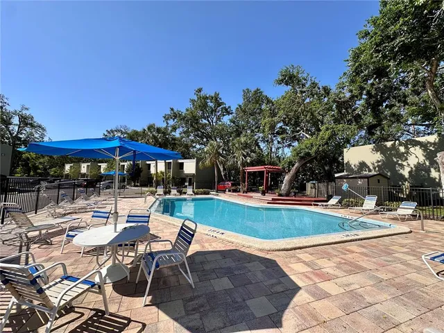 a view of a backyard with sitting area