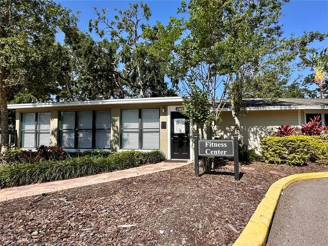 a front view of a house with garden and sitting area
