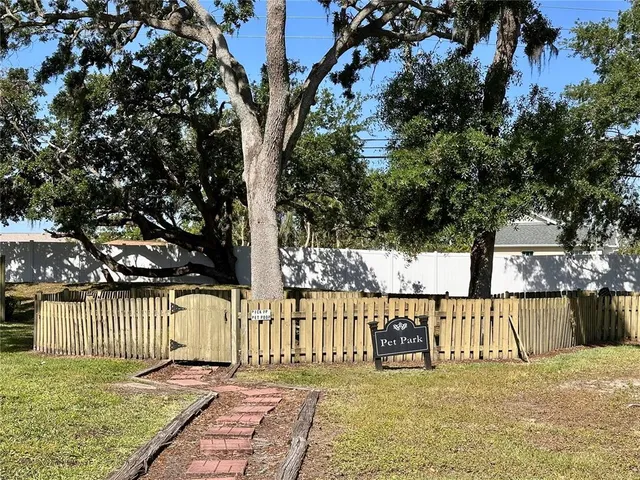 a view of a front of a house with a tree