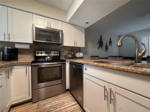a kitchen with a stove and a microwave
