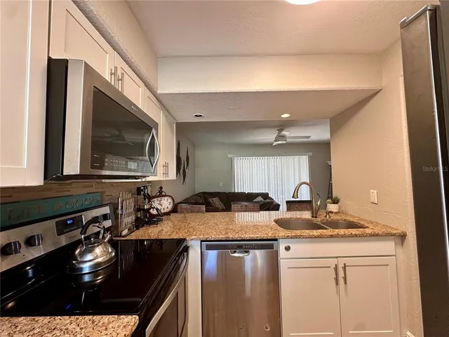 a kitchen with a stove a sink and a microwave