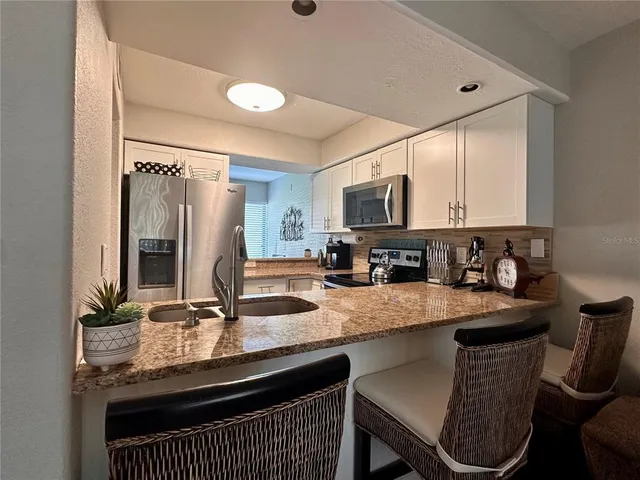 a kitchen with a sink cabinets and microwave