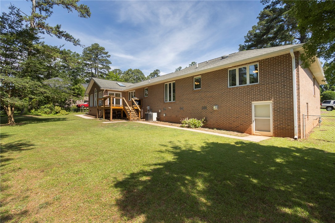 207 Laurel Ridge Road Anderson, SC 29621 - Photo 38 of 50 An inviting rear yard, complete with a deck and mature trees, offers outdoor enjoyment.