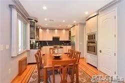a kitchen with stainless steel appliances kitchen island granite countertop a refrigerator and microwave