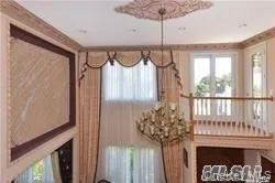 a front view of a house with a glass door and furniture