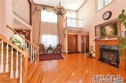 a living room with furniture a fireplace and a floor to ceiling window