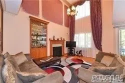 a living room with furniture fireplace and a large window