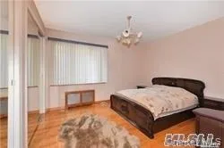 a spacious bedroom with a bed and a table