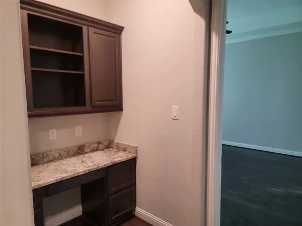 a kitchen with kitchen island granite countertop a sink appliances and cabinets