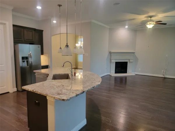 a view of kitchen with sink and wooden floor