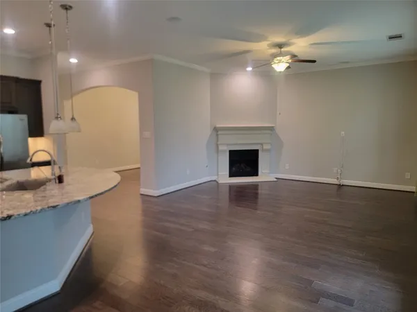 a kitchen with granite countertop kitchen island stainless steel appliances a sink stove and refrigerator