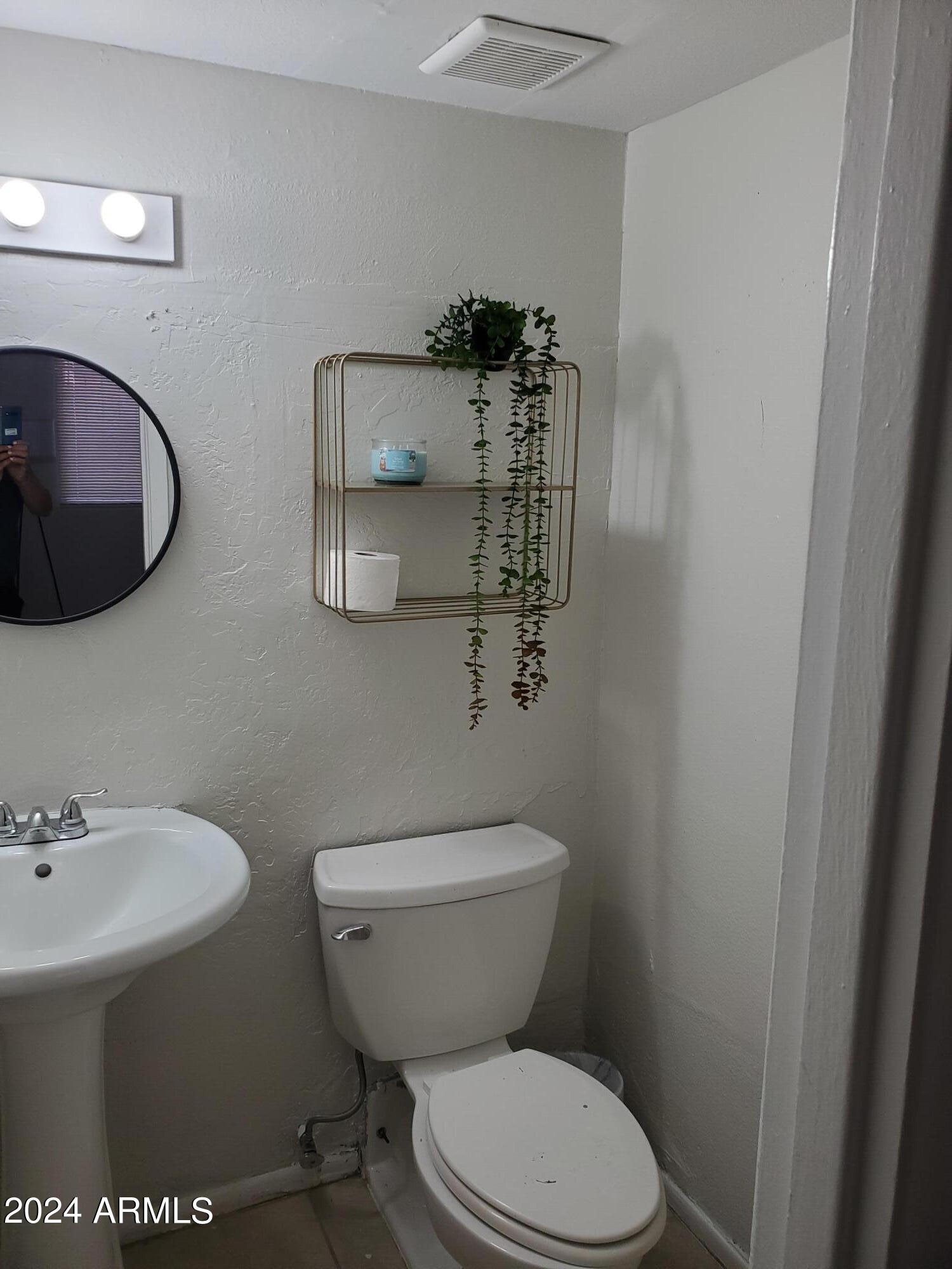 4010 West Wonderview Road Phoenix, AZ 85019 - Photo 3 of 9 a bathroom with a toilet and sink
