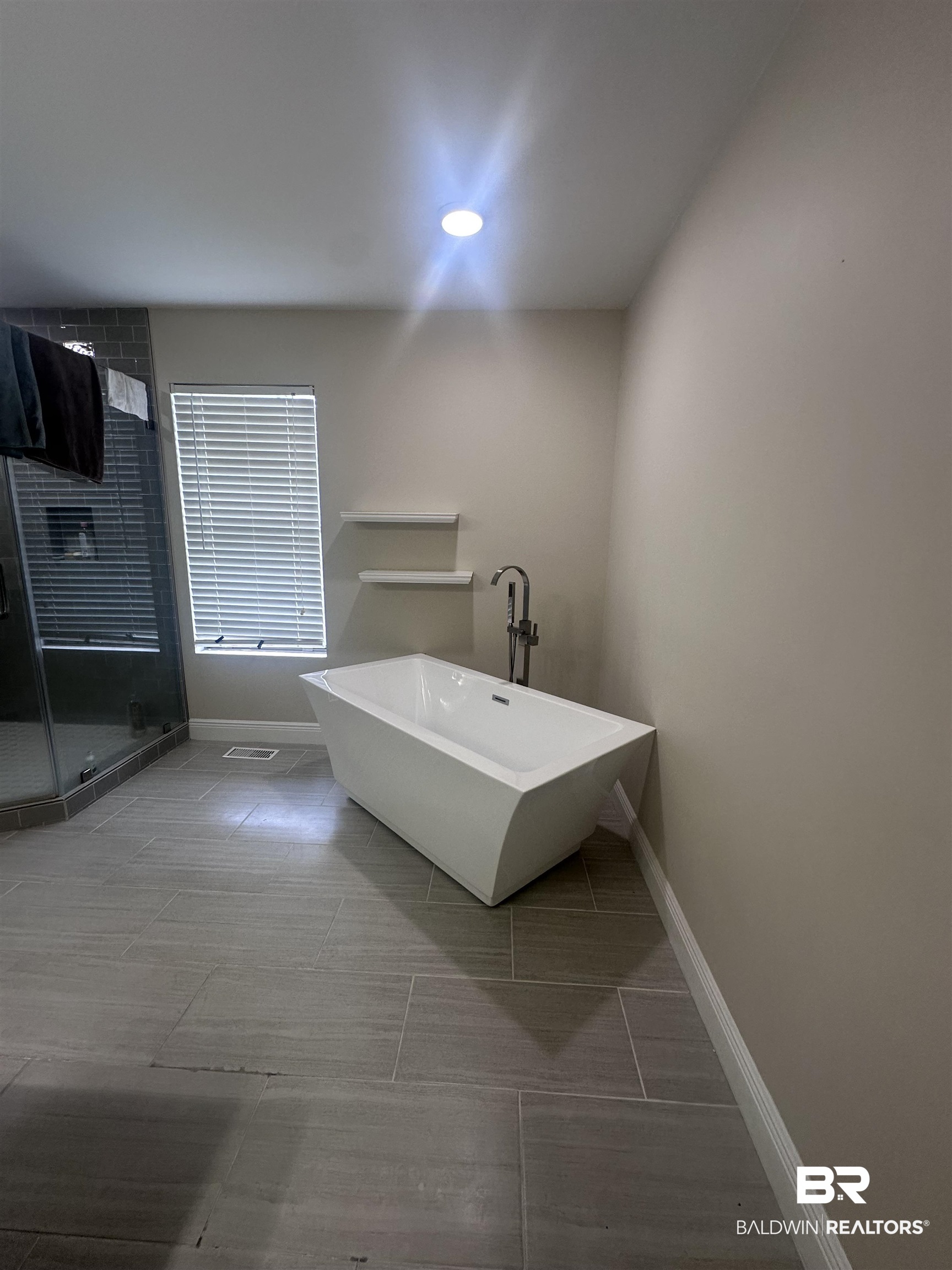2785 Sowell Road Brewton, AL 36426 - Photo 11 of 24 Full bathroom featuring a freestanding tub, a stall shower, and light tile patterned flooring