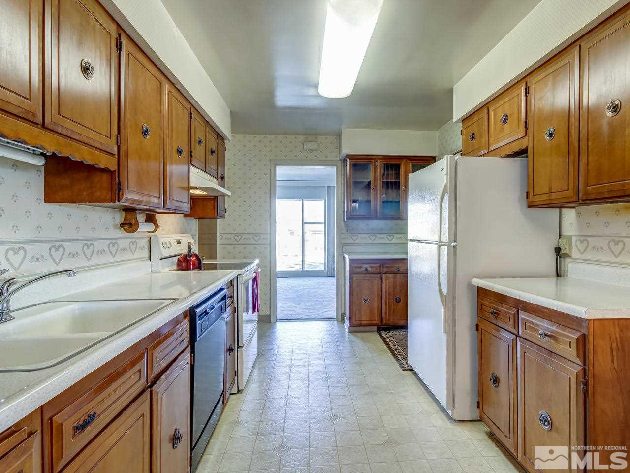 751 Balzar Circle Reno, NV 89502 - Photo 5 of 25 a kitchen with stainless steel appliances granite countertop a sink stove and refrigerator