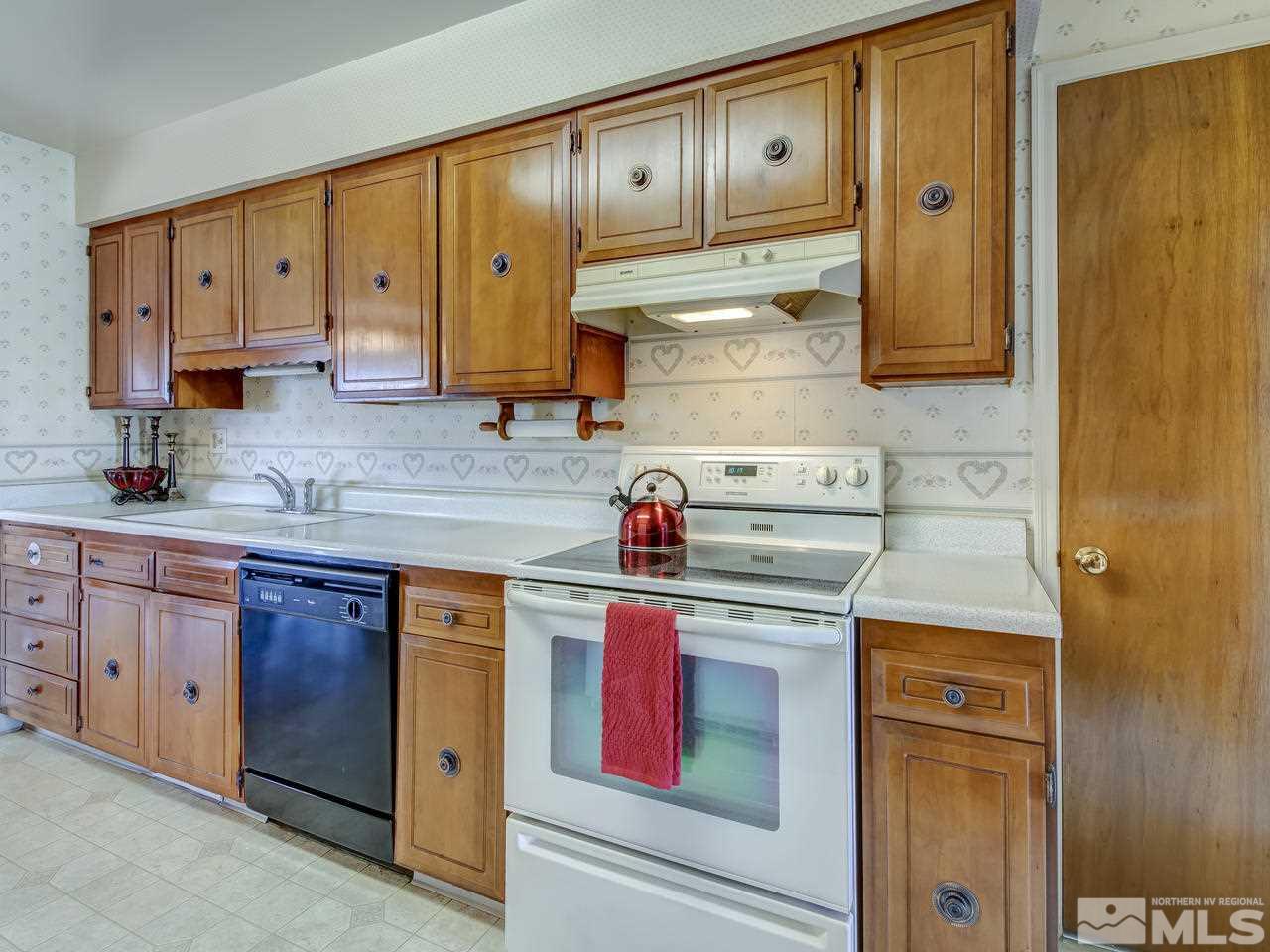 751 Balzar Circle Reno, NV 89502 - Photo 7 of 25 a kitchen with stainless steel appliances granite countertop a stove and cabinets