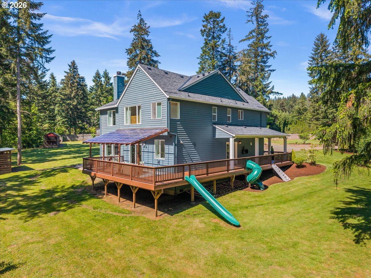 28311 Northwest Nowakowski Road Buxton, OR 97109 - Photo 42 of 48 a view of a house with a yard deck and a slide