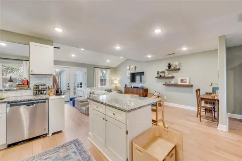 a kitchen with stainless steel appliances kitchen island granite countertop a sink and cabinets