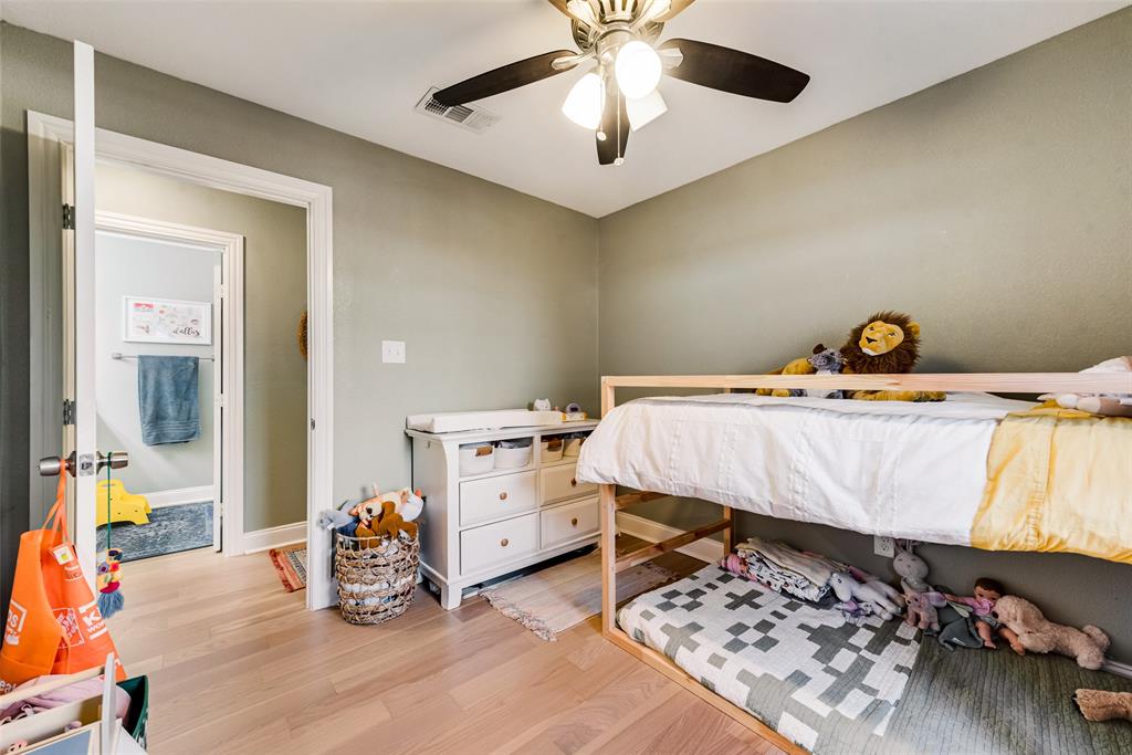 2522 Millmar Drive Dallas, TX 75228 - Photo 18 of 27 a bed room with a bed and a baby bed