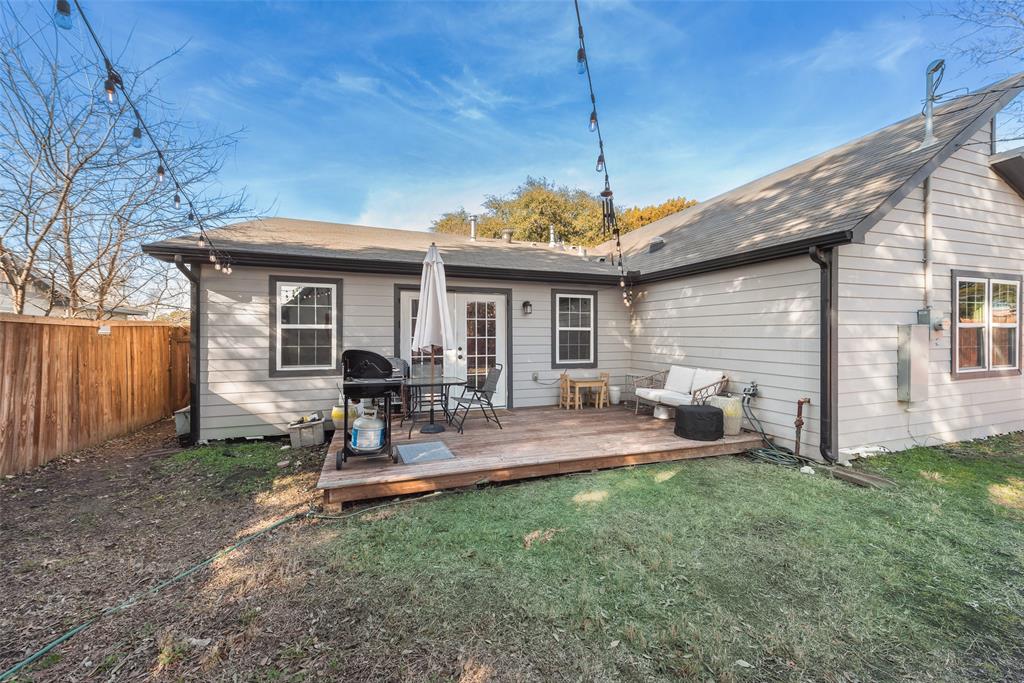 2522 Millmar Drive Dallas, TX 75228 - Photo 26 of 27 a view of a backyard with table and chairs under an umbrella