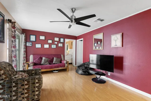 a bedroom with bed and a flat screen tv