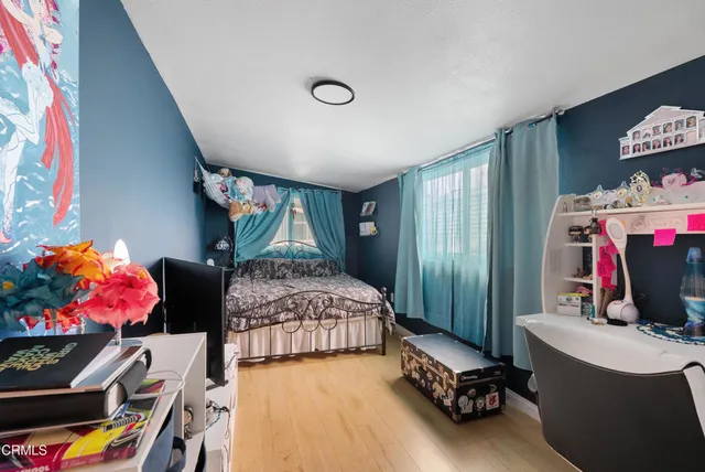 a bedroom with bed and a window