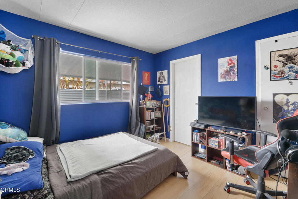 265 Beckwith Road, Unit 57 Santa Paula, CA 93060 - Photo 15 of 22 a bedroom with a bed and a flat screen tv