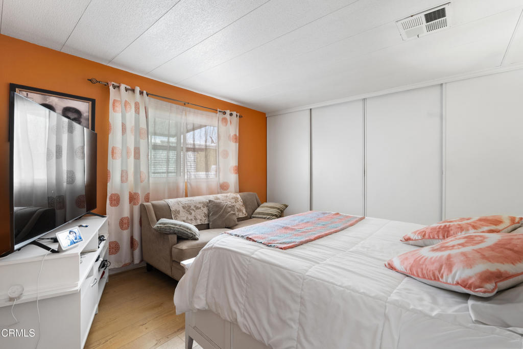 265 Beckwith Road, Unit 57 Santa Paula, CA 93060 - Photo 17 of 22 a bedroom with bed couch and window