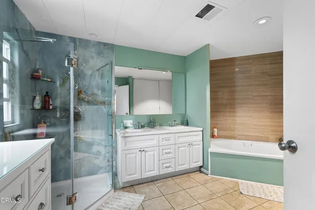 a bathroom with a granite countertop sink a toilet and shower