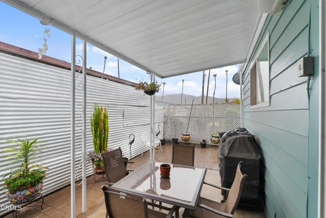 a balcony view with a couch and potted plants