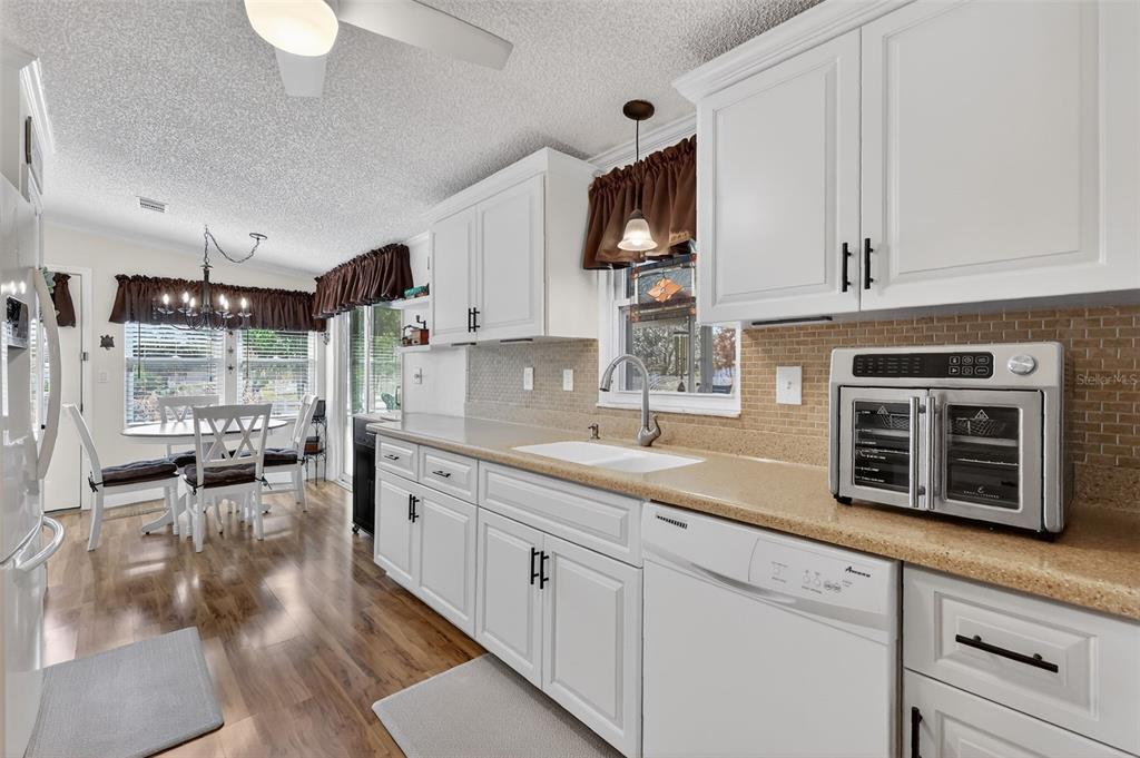 469 Santa Fe Road Tavares, FL 32778 - Photo 14 of 37 a kitchen with stainless steel appliances granite countertop a stove a sink and a white cabinets