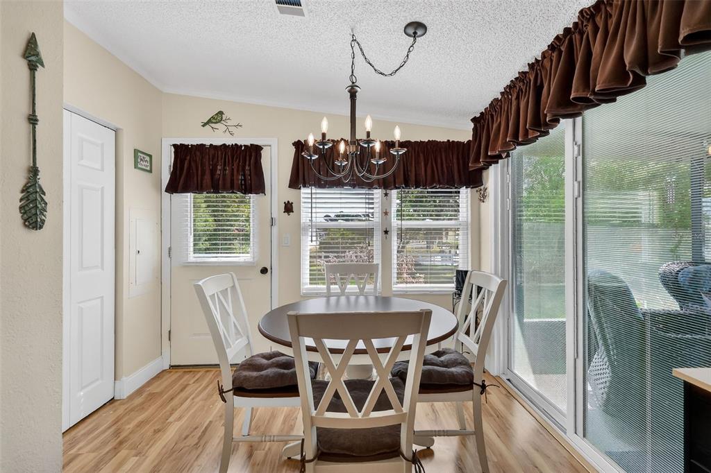 469 Santa Fe Road Tavares, FL 32778 - Photo 16 of 37 a dining room with furniture a chandelier and wooden floor