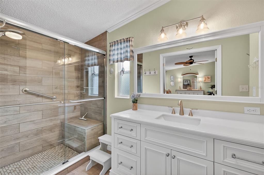469 Santa Fe Road Tavares, FL 32778 - Photo 21 of 37 a bathroom with a double vanity sink mirror and shower
