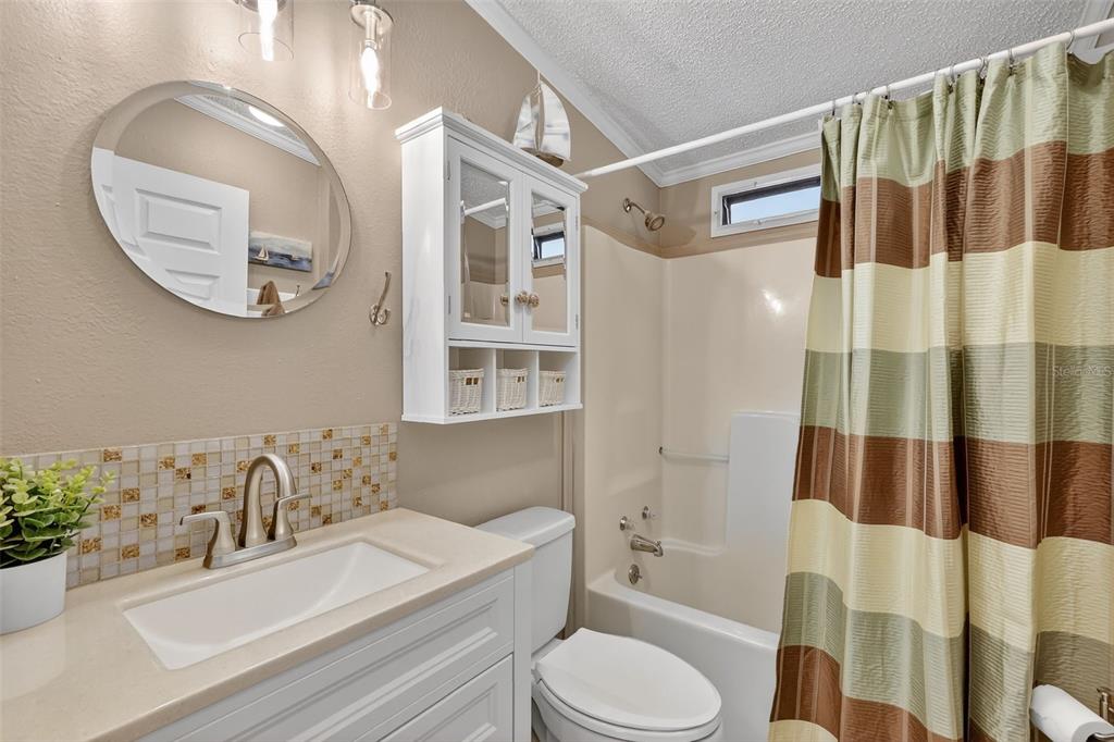 469 Santa Fe Road Tavares, FL 32778 - Photo 23 of 37 a bathroom with a sink a toilet and shower