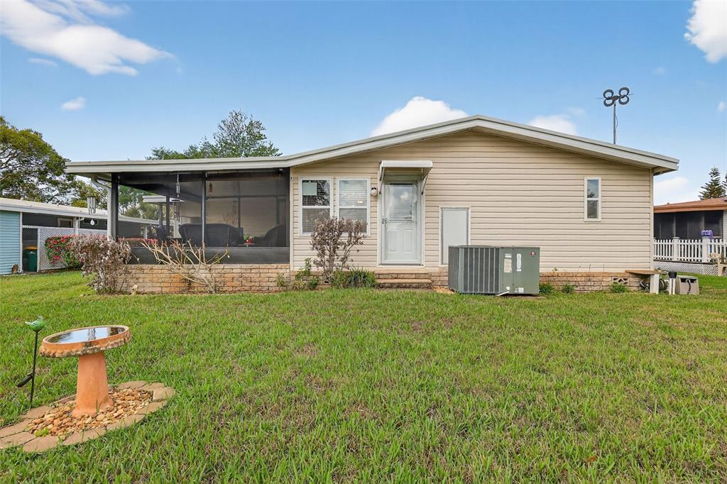 469 Santa Fe Road Tavares, FL 32778 - Photo 28 of 37 a front view of a house with a garden