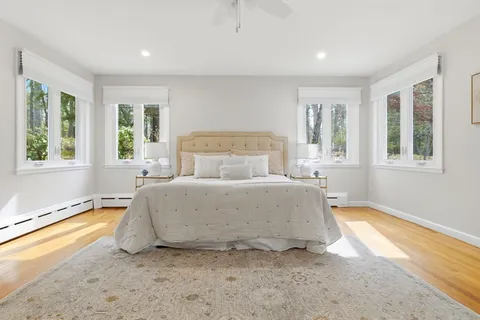 a spacious bedroom with a bed and a large window