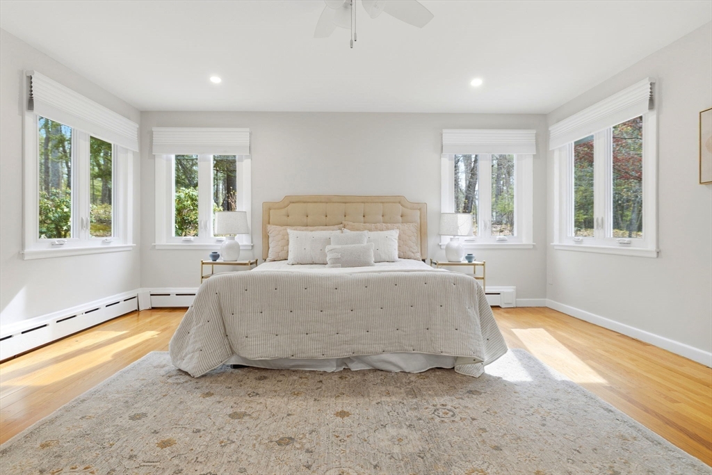 31 Huckleberry Hill Road Lincoln, MA 01773 - Photo 13 of 27 a spacious bedroom with a bed and a large window