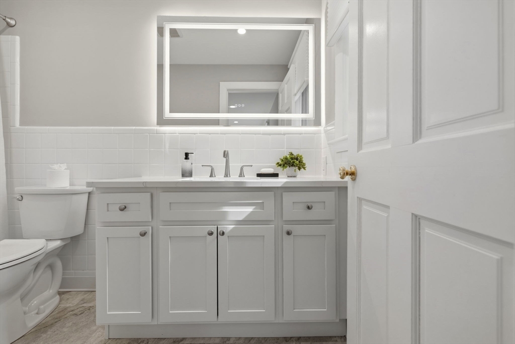 31 Huckleberry Hill Road Lincoln, MA 01773 - Photo 15 of 27 a bathroom with a sink a toilet and a mirror