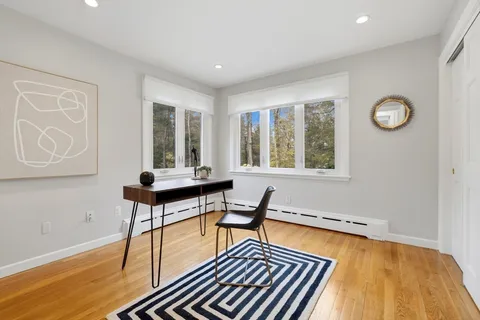 a bedroom with furniture window and wooden floor