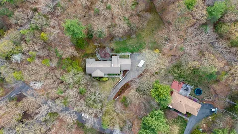 an aerial view of a house with outdoor space
