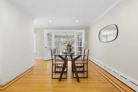 a dining room with furniture and wooden floor