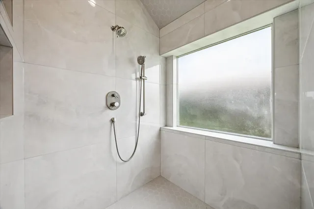 a bathroom with a glass shower door
