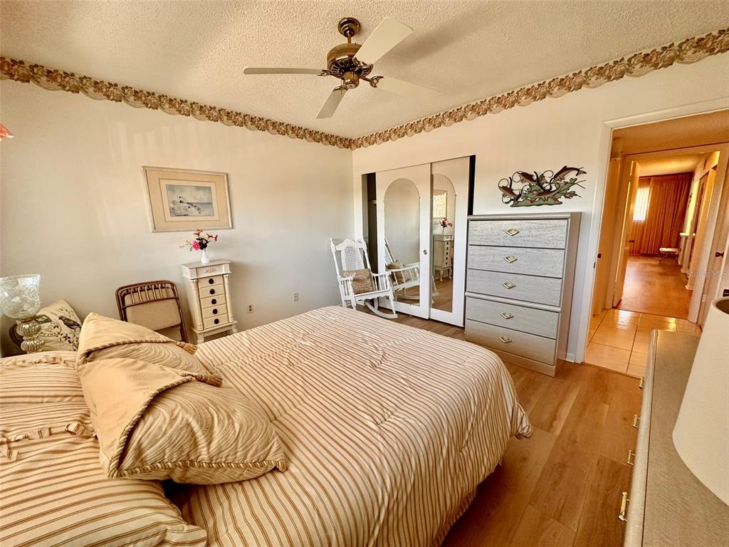 2340 Grecian Way, Unit 56 Clearwater, FL 33763 - Photo 13 of 40 a bedroom with a bed and a chandelier