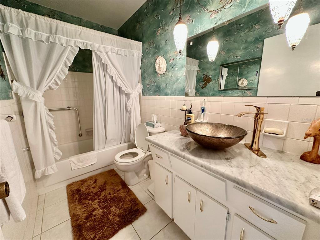 2340 Grecian Way, Unit 56 Clearwater, FL 33763 - Photo 14 of 40 a bathroom with a toilet a sink and a mirror