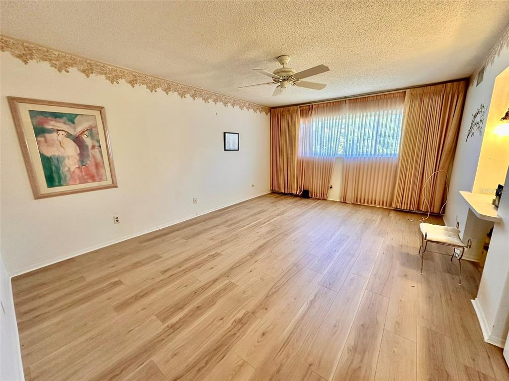 2340 Grecian Way, Unit 56 Clearwater, FL 33763 - Photo 16 of 40 wooden floor in an empty room with a window