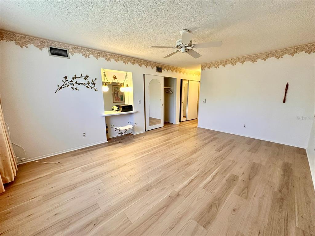 2340 Grecian Way, Unit 56 Clearwater, FL 33763 - Photo 18 of 40 wooden floor in an empty room